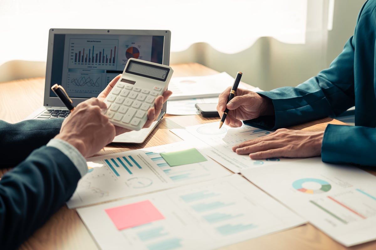 Tax professionals discussing financial documents and charts during a business meeting